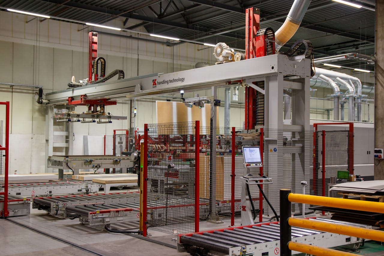 Industrial machinery with robotic arm in a modern manufacturing facility.